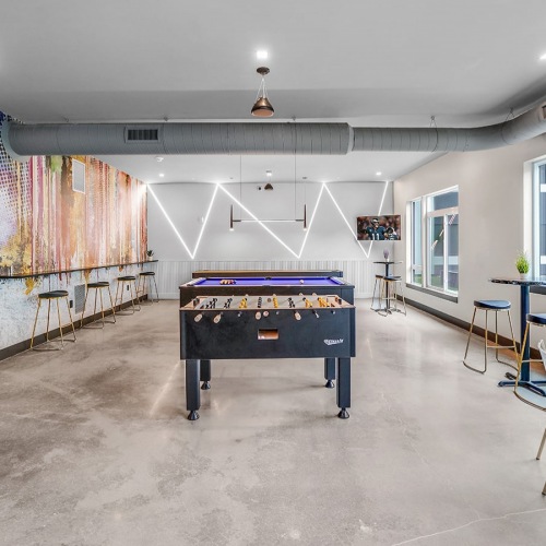 spacious game room with billiards and modern decor